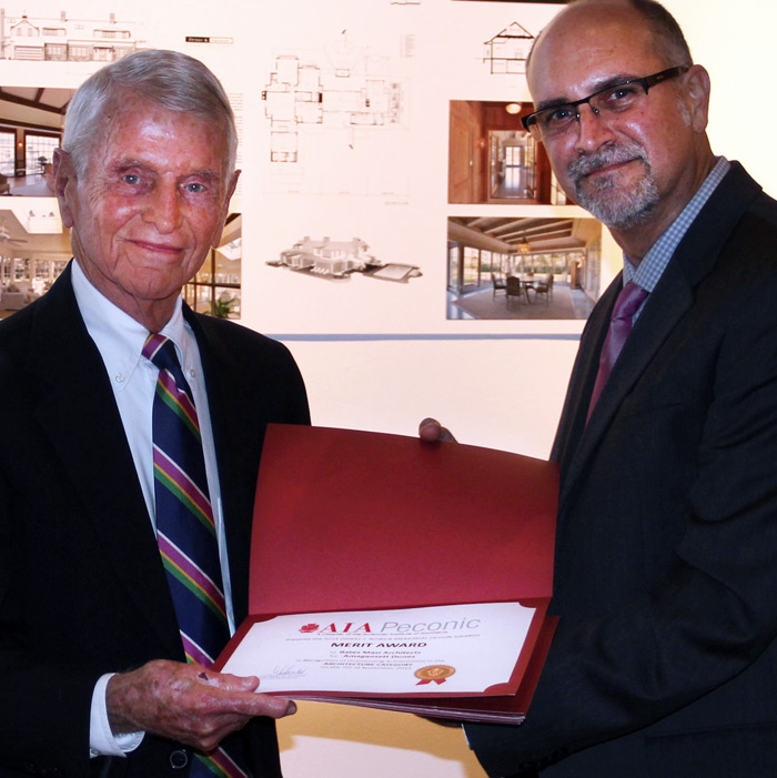 Peconic AIA President Luis Peris gives a Merit Award to Harry Bates from Bates Masi