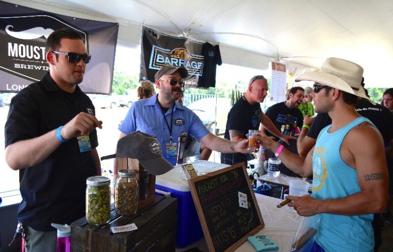 Ed Docyk and Matt Spitz of Moustache Brewing Co. in Riverhead serve to Mike DeNicola.