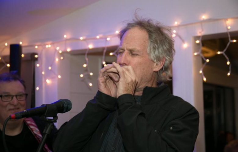 Jim Turner adds his notorious harmonica lyrics to the jam at East End Opry at Coast Grill