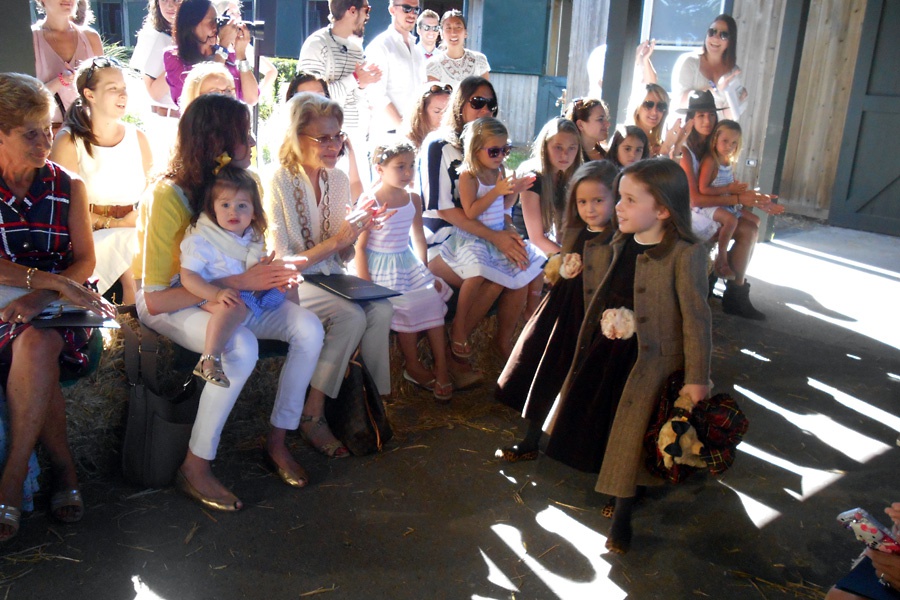 Models walking down the barn runway in fall coats at Ralph Laren Presents Fall 2013 Girls Fashion Show at Wolffer Stables.