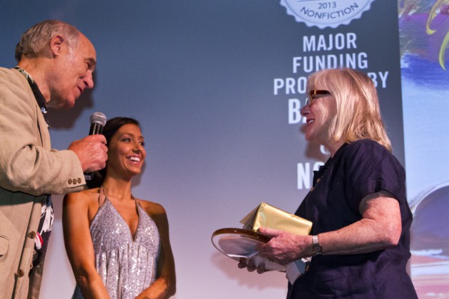 Susan Duff accepts the grand prize for her piece "Moving Through Water"