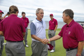 Former President George W. Bush shakes hands with Captain Jim Holtgrieve during a practice round with the USA Walker Cup team at the 2013 Walker Cup at National Golf Links of America in Southampton on Thursday. ©USGA/John Mummert