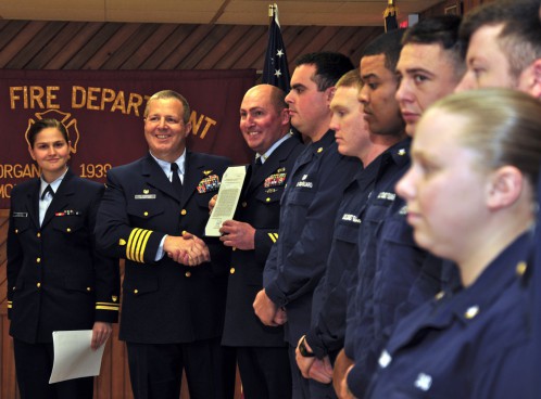Coast Guard Capt. Edward J. Cubanski presents crew members of Station Montauk with the Meritorious Team Commendation.