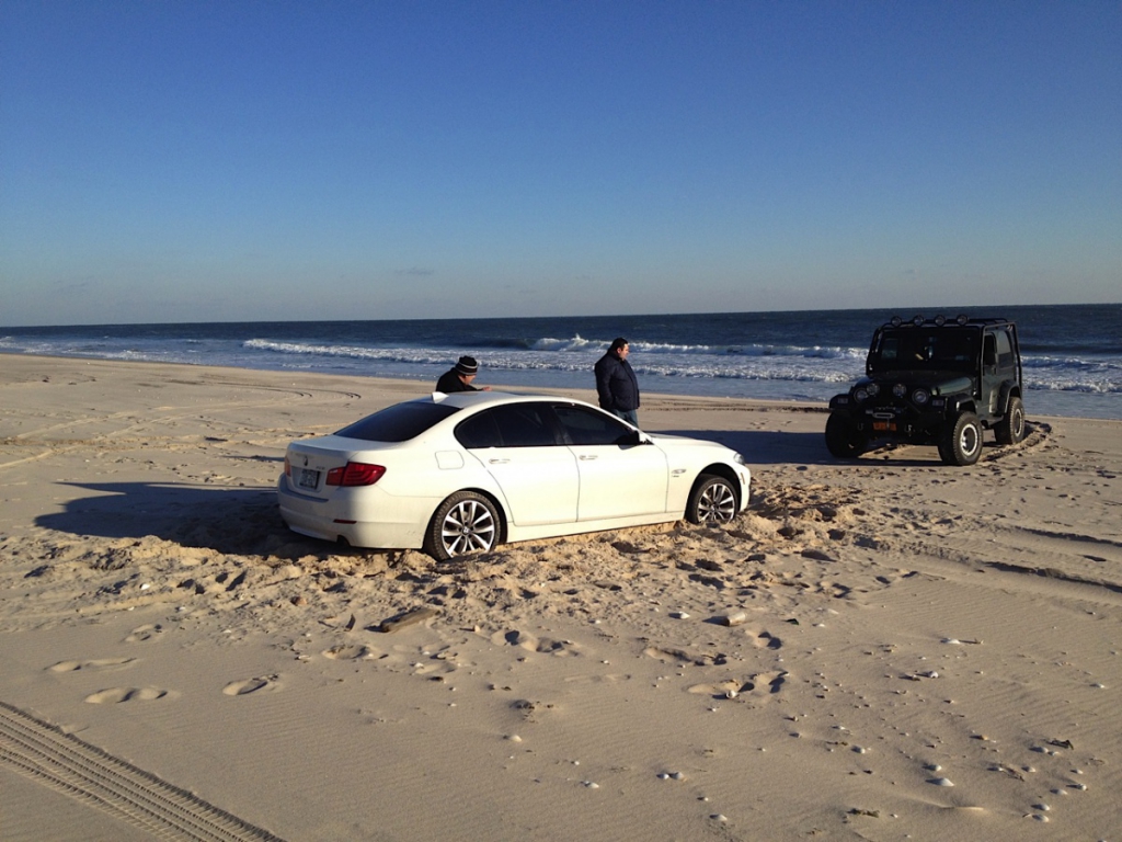 BMW stuck in the sand at Old Town Beach, Southampton Village.