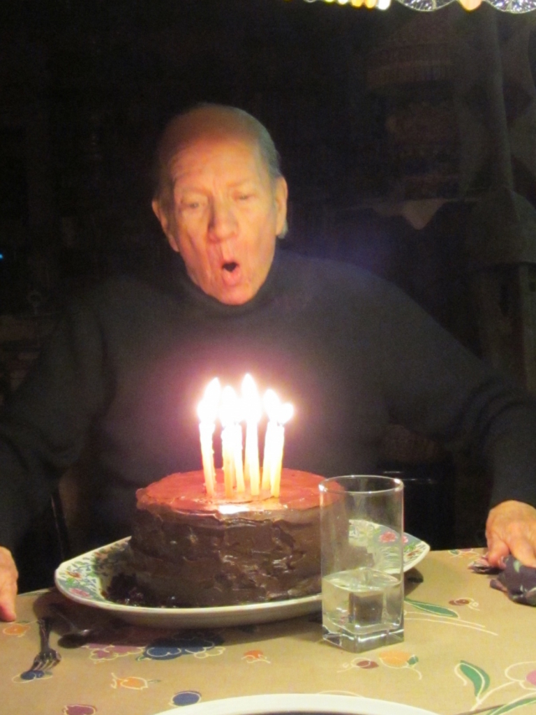 Gahan Wilson blows out the candles on his birthday cake.