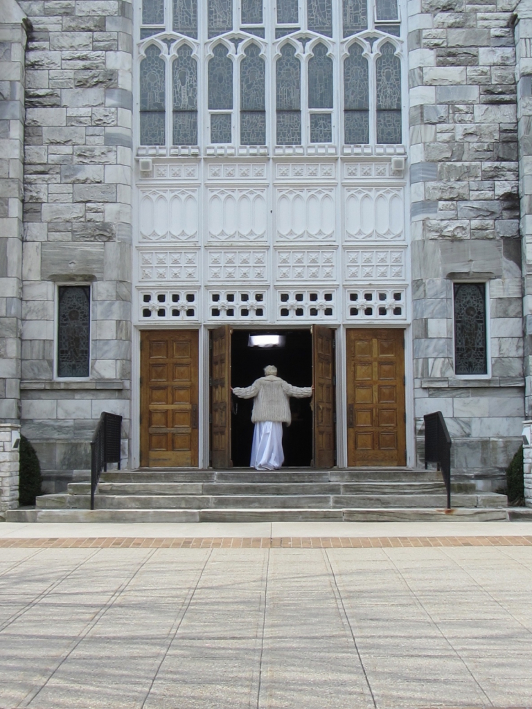 Rebecca Kiembock enters Basilica Parish of the Sacred Hearts of Jesus and Mary.