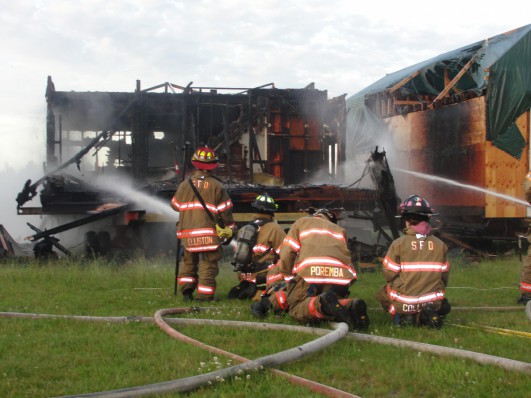 Firefighters soak down an unoccupied residence on the Shinnecock Indian Reservation. Photo credit: Courtesy Southampton Fire Department