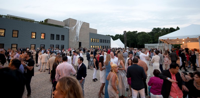 The courtyard filled with Watermill Center summer benefit guests amid art and performance artists.
