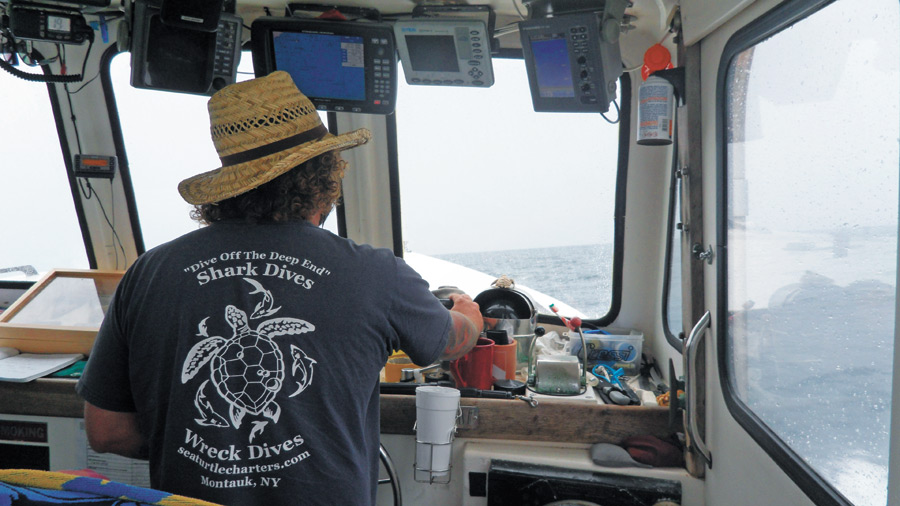 Captain Chuck Wade driving his boat, the Sea Turtle