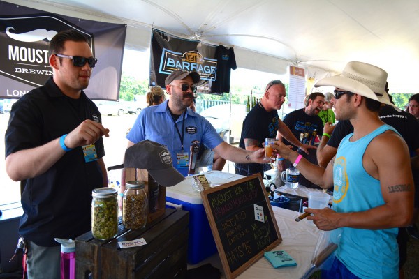 Ed Docyk and Matt Spitz of Moustache Brewing Co. in Riverhead serve to Mike DeNicola.