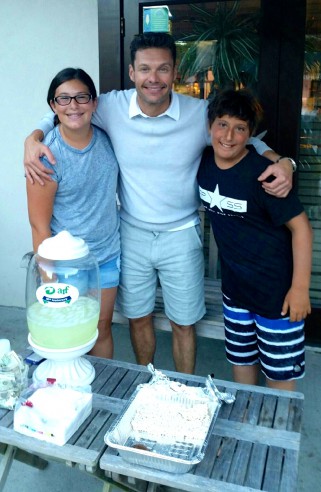 Molly and Alan Vashovsky sell lemonade to Ryan Seacrest at their Lemonarf Stand outside Red Horse Market in East Hampton.