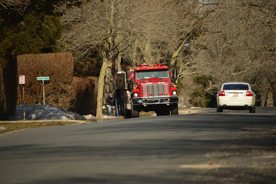 Firefighters fill a tanker truck with water to bring it to West End Avenue, where a mansion burned.