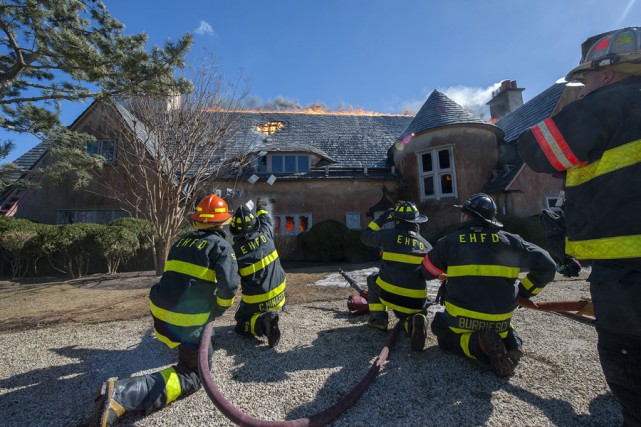 At 2:35 p.m. on Wednesday, March 18th, 2015, members of the East Hampton Fire Department responded to the Morton residence for a report of a structure fire. First arriving units found the structure, which was under renovation at the time, heavily involved with fire. Mutal aid was called from the Montauk, Amagansett, Springs, Sag Harbor, Bridgehampton, Southampton and Hampton Bays Fire Departments, and the North Sea Fire Department was called to stand by at the EHFD headquarters. Cold temperatures, a strong wind and water supply challenges made fighting the fire difficult, and eventually heavy equipment was called for to knock the chimneys over and remove debrisi so that all remaining pockets of fire could be extinguished. I was not until well after that 9:00 p.m. that evening that all units were fully back in service. It was suspected that roofers installing new flashing were to blame for the fire, but the East Hampton Village Fire Marshal's office responded and was on scene to determine the fire's cause and origin.