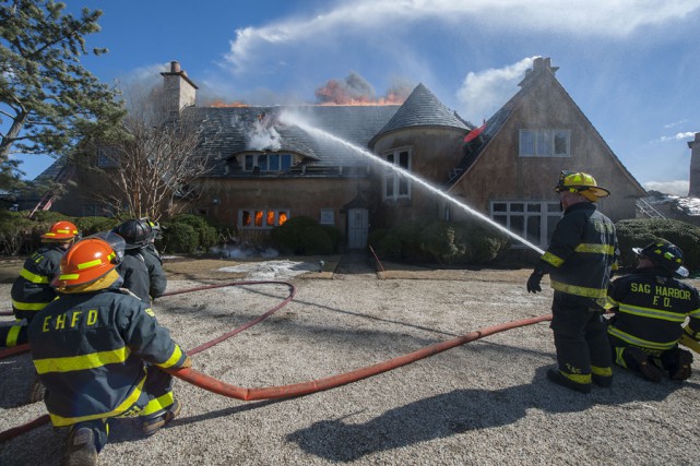 At 2:35 p.m. on Wednesday, March 18th, 2015, members of the East Hampton Fire Department responded to the Morton residence for a report of a structure fire. First arriving units found the structure, which was under renovation at the time, heavily involved with fire. Mutal aid was called from the Montauk, Amagansett, Springs, Sag Harbor, Bridgehampton, Southampton and Hampton Bays Fire Departments, and the North Sea Fire Department was called to stand by at the EHFD headquarters. Cold temperatures, a strong wind and water supply challenges made fighting the fire difficult, and eventually heavy equipment was called for to knock the chimneys over and remove debrisi so that all remaining pockets of fire could be extinguished. I was not until well after that 9:00 p.m. that evening that all units were fully back in service. It was suspected that roofers installing new flashing were to blame for the fire, but the East Hampton Village Fire Marshal's office responded and was on scene to determine the fire's cause and origin.