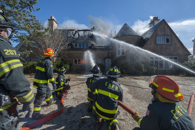 At 2:35 p.m. on Wednesday, March 18th, 2015, members of the East Hampton Fire Department responded to the Morton residence for a report of a structure fire. First arriving units found the structure, which was under renovation at the time, heavily involved with fire. Mutal aid was called from the Montauk, Amagansett, Springs, Sag Harbor, Bridgehampton, Southampton and Hampton Bays Fire Departments, and the North Sea Fire Department was called to stand by at the EHFD headquarters. Cold temperatures, a strong wind and water supply challenges made fighting the fire difficult, and eventually heavy equipment was called for to knock the chimneys over and remove debrisi so that all remaining pockets of fire could be extinguished. I was not until well after that 9:00 p.m. that evening that all units were fully back in service. It was suspected that roofers installing new flashing were to blame for the fire, but the East Hampton Village Fire Marshal's office responded and was on scene to determine the fire's cause and origin.