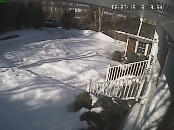 On the top left side of the image, the white van can be seen parked at the end of the driveway.