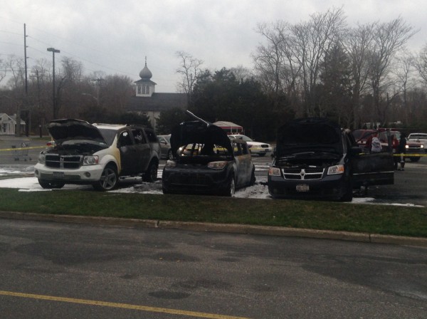 Car fire and explosion in Eastport King Kullen shopping center parking lot destroyed three vehicles and sent a man to the hospital. Photo credit: Brendan J. O'Reilly