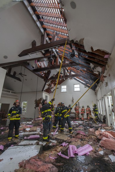 Members of the Southampton, North Sea, Hampton Bays, Bridgehampton, Sag Harbor and East Hampton Fire Departments fight a fire in a vacant building at 337 Montauk Highway in Water Mill, NY on Saturday, May 9th, 2015