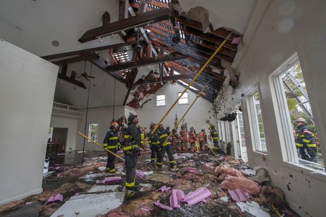 Members of the Southampton, North Sea, Hampton Bays, Bridgehampton, Sag Harbor and East Hampton Fire Departments fight a fire in a vacant building at 337 Montauk Highway in Water Mill, NY on Saturday, May 9th, 2015