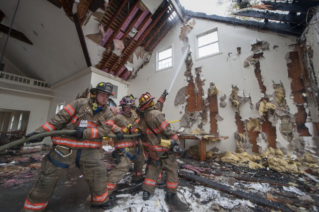 Members of the Southampton, North Sea, Hampton Bays, Bridgehampton, Sag Harbor and East Hampton Fire Departments fight a fire in a vacant building at 337 Montauk Highway in Water Mill, NY on Saturday, May 9th, 2015