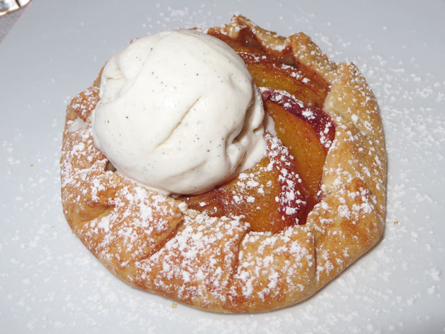 Rustic Peach Tart and scoop of vanilla ice cream.