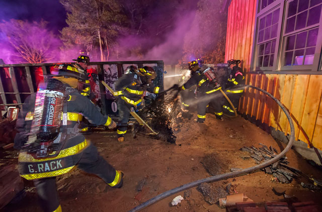 East Hampton firefighters extinguish a dumpster fire Sunday. Photo credit: Michael Heller