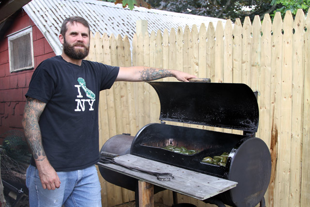 Randy Kopke smokes peppers.