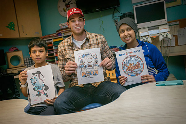 Mets pitcher Steven Matz with Stony Brook Children’s patients Nicholas Reinoso, left, and Anmol Jaswal, both displaying their Mets’ themed colored drawings, which Matz autographed.