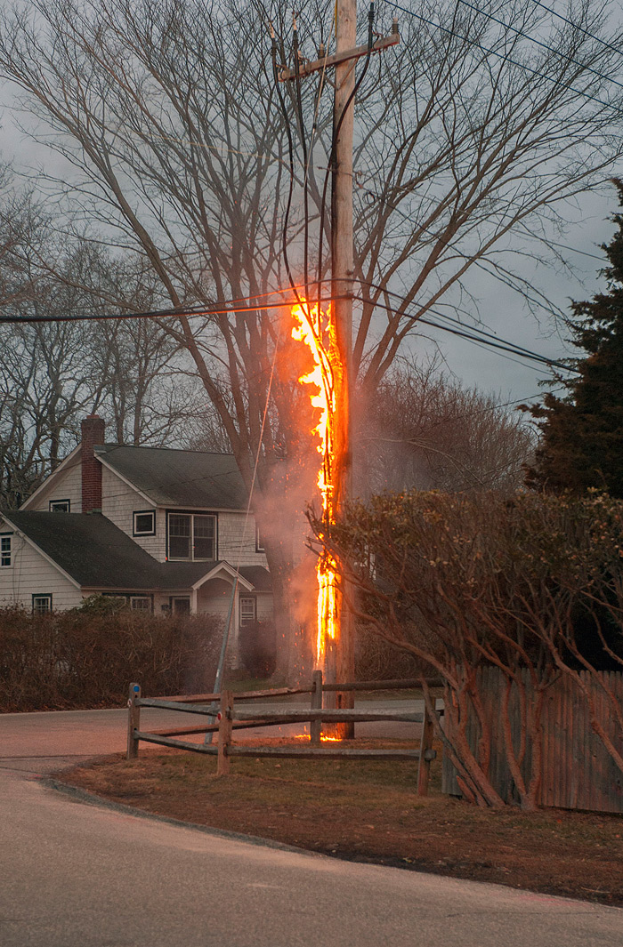 A telephone pole burns in East Hampton on February 23