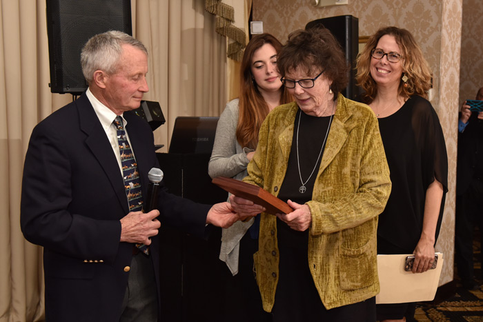 Diane and Melinda Novak, with daughter Chela, receive the Phoenix Award from Dr. John Andresen