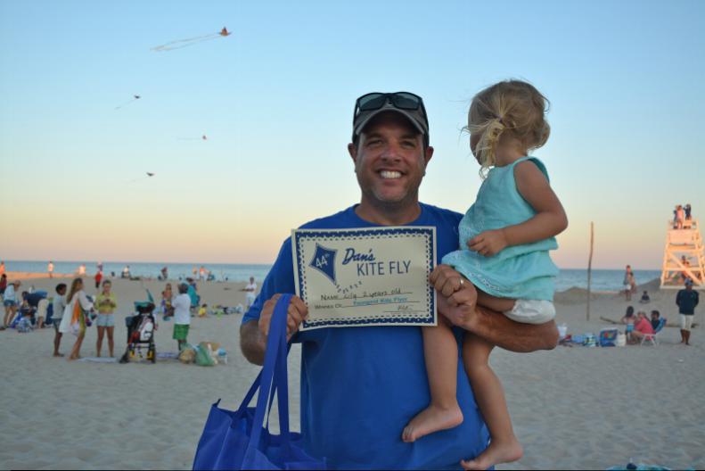 Youngest Kite Flyer winner, 2-year-old Lily and her proud father