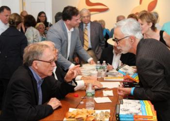 Dick Cavett autographs his book at the meet and greet