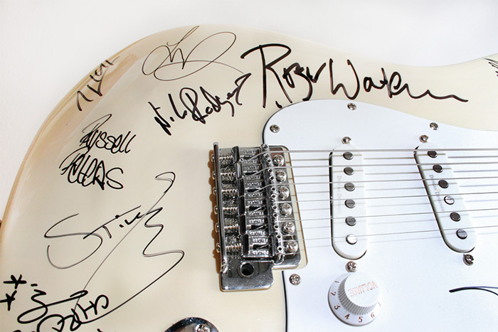 AFTEE guitar with autographs from Roger Waters, Sting, Adam Lambert, Nile Rodgers, Avicii and more