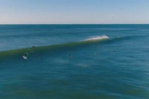 Surfers ride glassy waves in Montauk