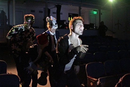 Mercutio (Charlie Westfal) leads Benvolio (Quinn Jackson) and friends down center aisle