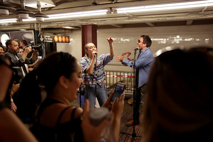 Jimmy Fallon and Miley Cyrus singing on a subway platform