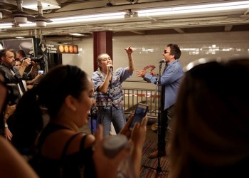 Jimmy Fallon and Miley Cyrus singing on a subway platform