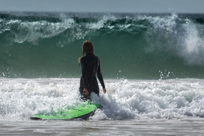 Female surfer entering water