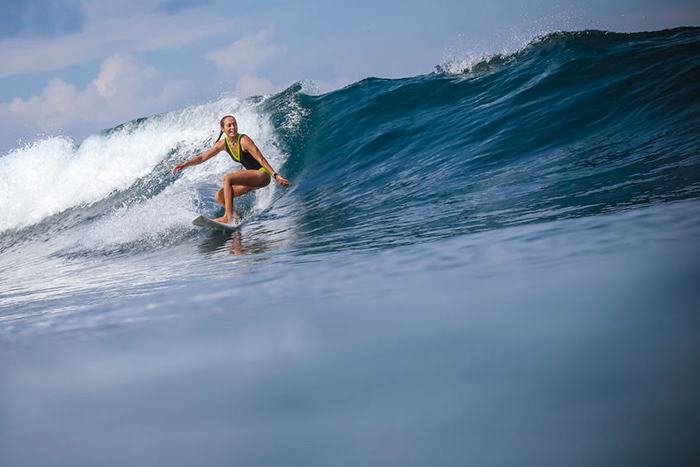 Female surfer riding wave