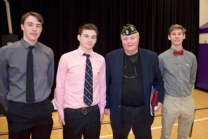 Thomas Gately with Hampton Bays high school seniors (from left) Jordan Phillips, Shane Riscen and Keegan Schneider