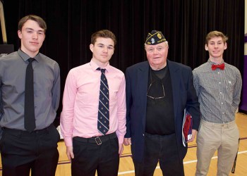 Thomas Gately with Hampton Bays high school seniors (from left) Jordan Phillips, Shane Riscen and Keegan Schneider