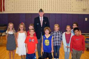 Hampton Bays Elementary School fourth-graders with honored veteran Jim Patton