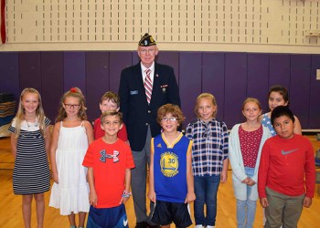 Hampton Bays Elementary School fourth-graders with honored veteran Jim Patton