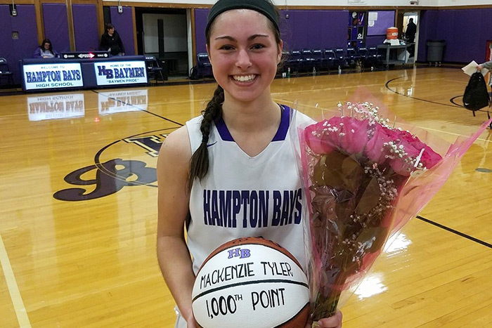 Hampton Bays High School basketball star MacKenzie Tyler celebrates her 1,000th point