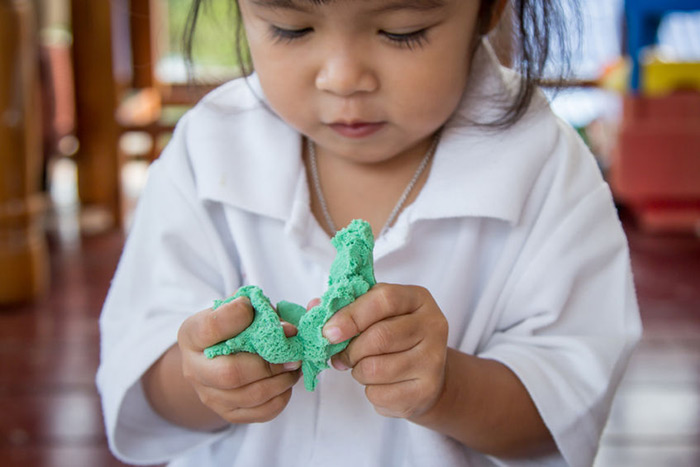 Cute kid playing with Play-Doh