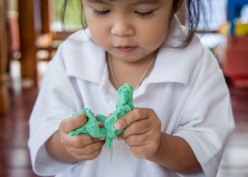 Cute kid playing with Play-Doh