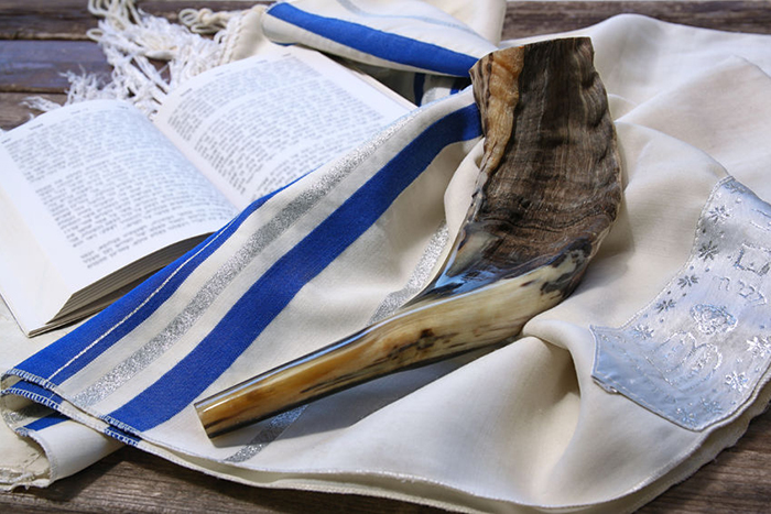 Shofar horn on white prayer talit for Rosh Hashanah