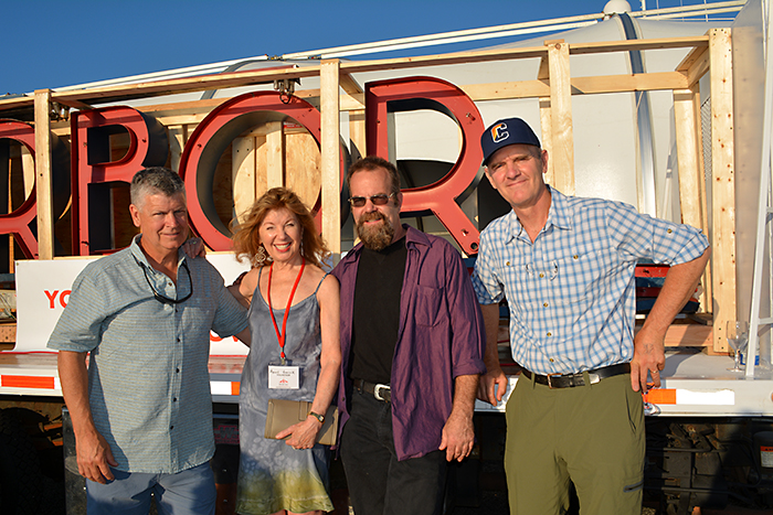 Chris Denon, April Gornik, Clayton Orehek and John Battle with the neon sign