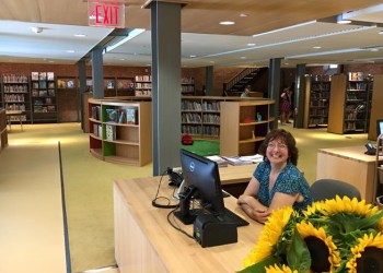Sue Farrell inside the new John Jermain Memorial Library