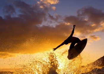 Sunset surfer gets air
